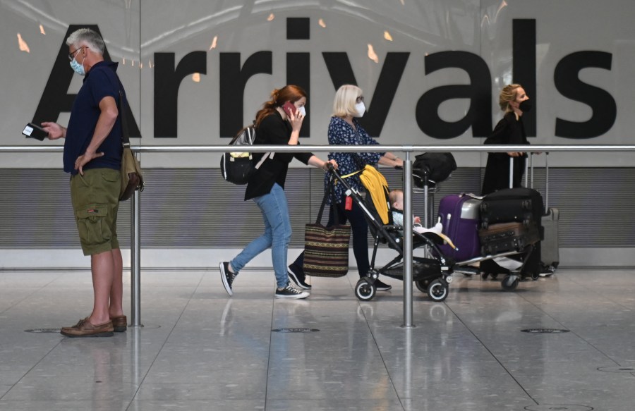 Travelers walk through Heathrow airport in London, on June 3, 2021. (DANIEL LEAL-OLIVAS/AFP via Getty Images)