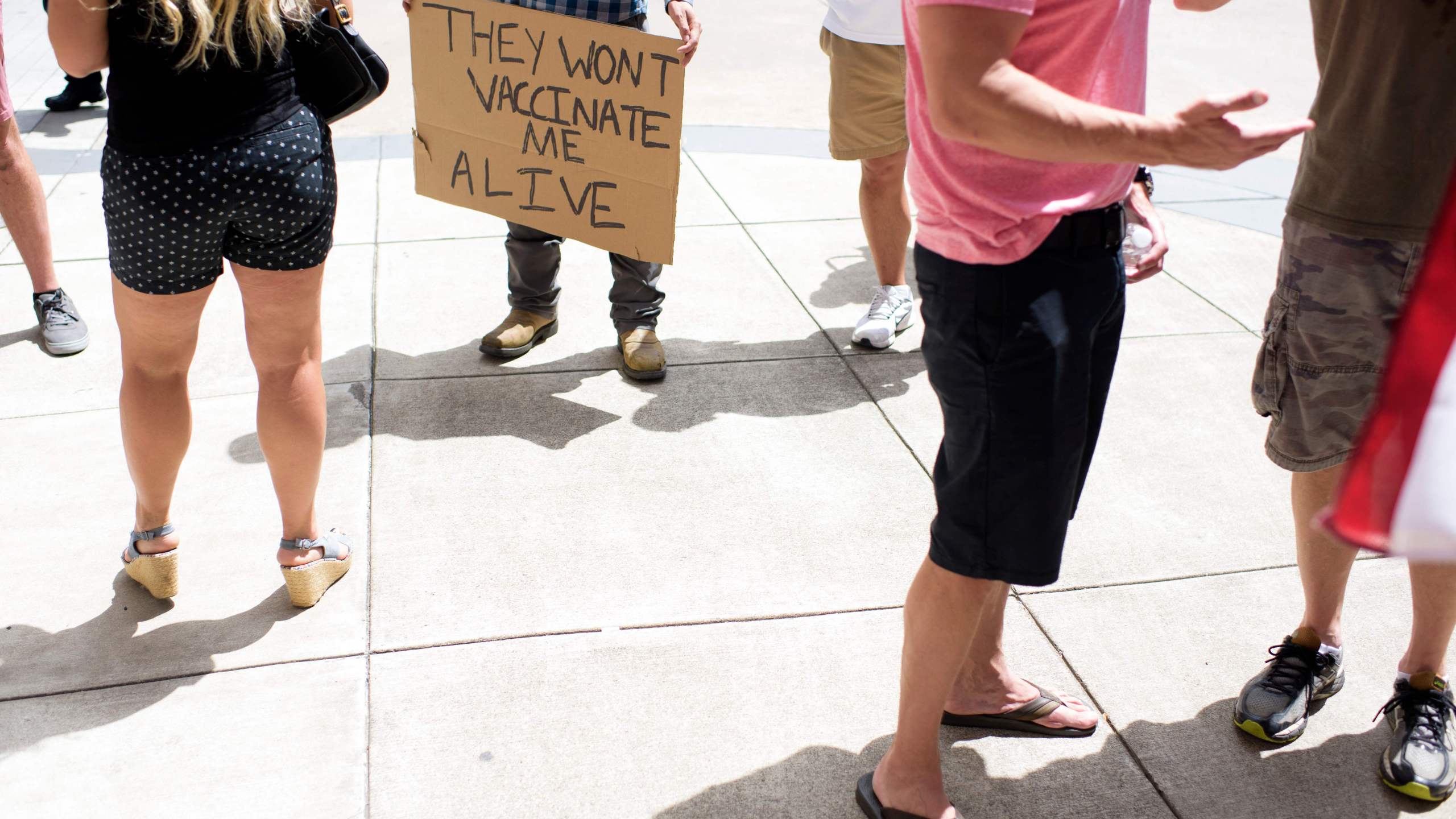 Anti-vaccine rally protesters hold signs outside of Houston Methodist Hospital in Houston, Texas, on June 26, 2021. (MARK FELIX/AFP /AFP via Getty Images)