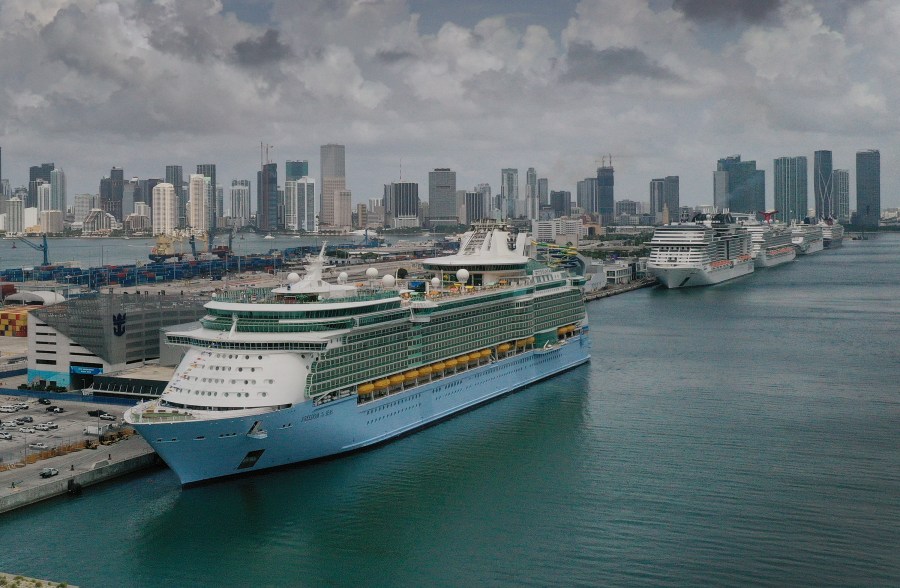 In an aerial view, the Royal Caribbean Freedom of the Seas (L) prepares to set sail from PortMiami during the first U.S. trial cruise testing COVID-19 protocols on June 20, 2021 in Miami, Florida. (Joe Raedle/Getty Images)