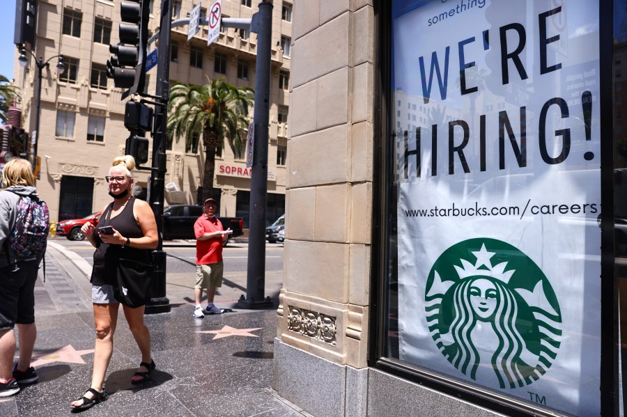 A 'We're Hiring!' sign is displayed at a Starbucks on Hollywood Boulevard on June 23, 2021 in Los Angeles. (Mario Tama/Getty Images)