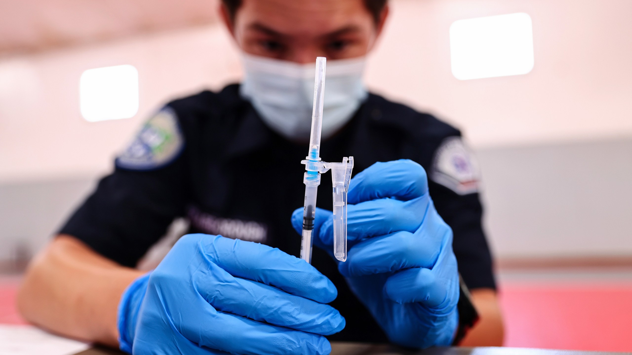 An EMT prepares a Pfizer vaccine dose during a pop-up COVID-19 vaccination clinic at James Jordan Middle School on July 6, 2021 in Winnetka, California. (Mario Tama/Getty Images)