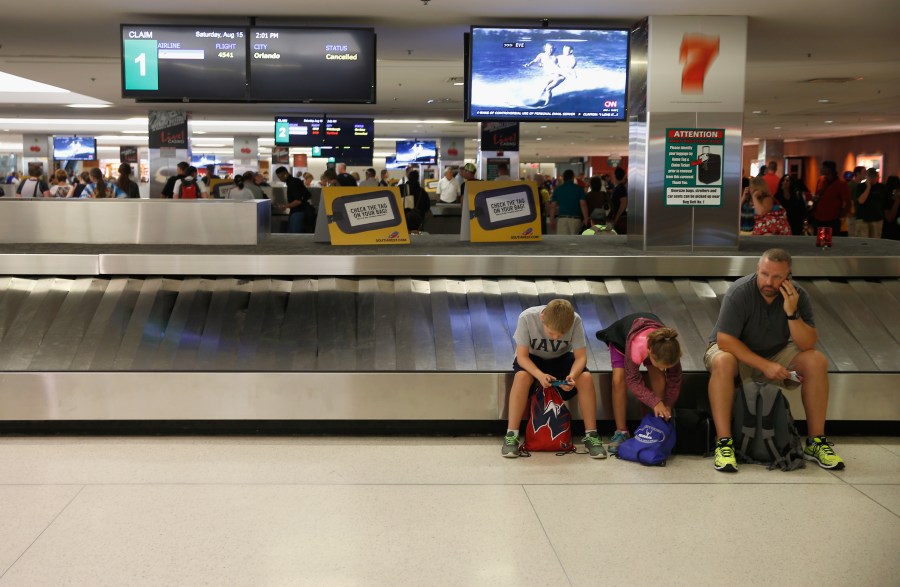 Passengers wait for bags at baggage claim in Baltimore/Washington International Thurgood Marshall Airport in Maryland in this Aug. 15, 2015 file photo. (Rob Carr/Getty Images)