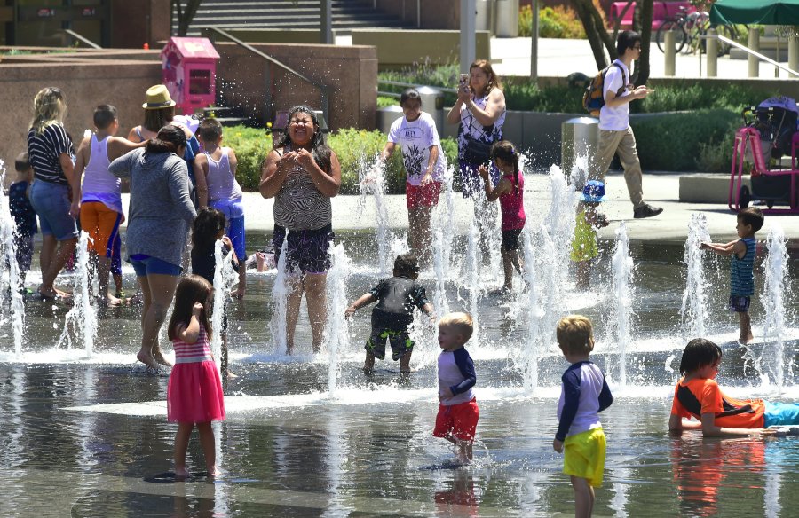 Children and adults cool off at the Grand Park splash pad in downtown Los Angeles, California on June 19, 2017, amid a Southern California heatwave with highs again forecast to hit triple-digits in some Los Anegels County communities. (Frederic J. Brown/AFP via Getty Images)