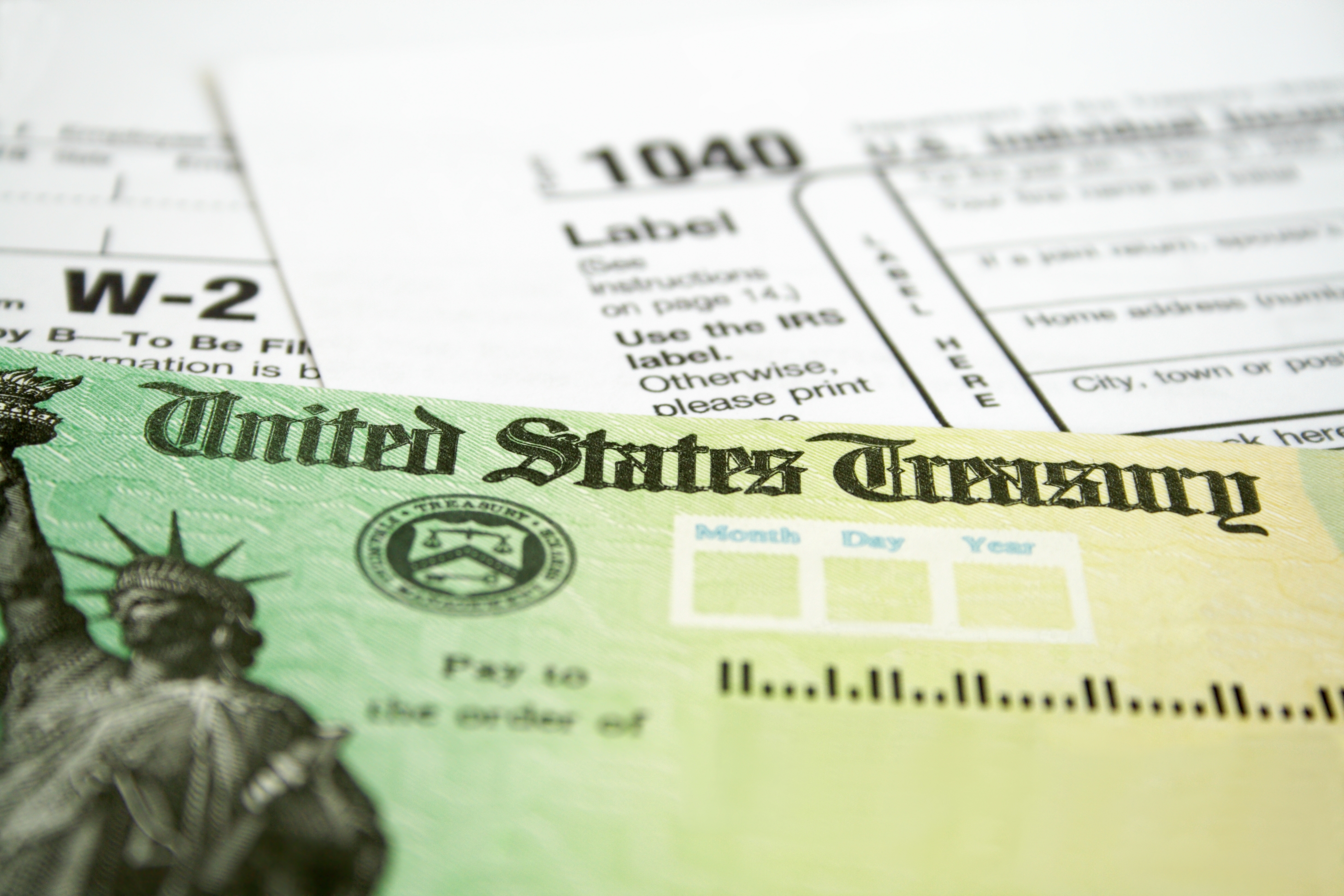 A U.S. Treasury check and a tax document are seen in a file photo. (iStock/Getty Images Plus)