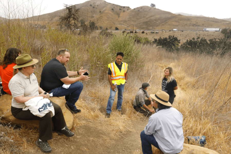 obert Rock, principal architect from Living Habitats, third from left, speaks to the group about plans for the wildlife bridge on June 20, 2021.(Carolyn Cole/Los Angeles Times)