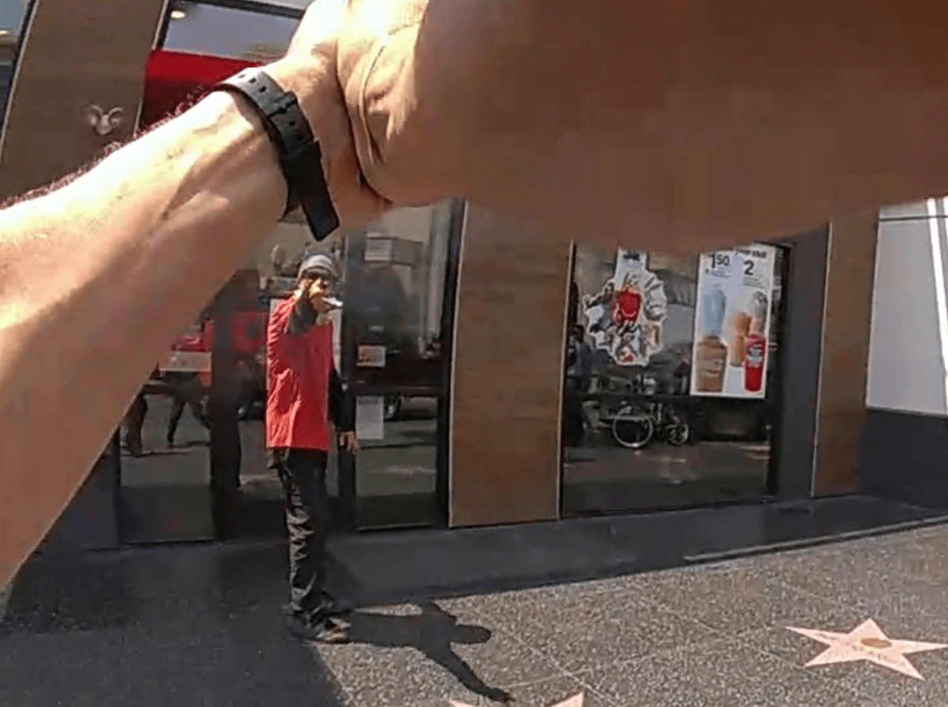 Body camera footage shows a man pointing an object at Los Angeles police officers on Hollywood Boulevard on Thursday just before they fatally shot him on July 15, 2021. (Los Angeles Police Department)