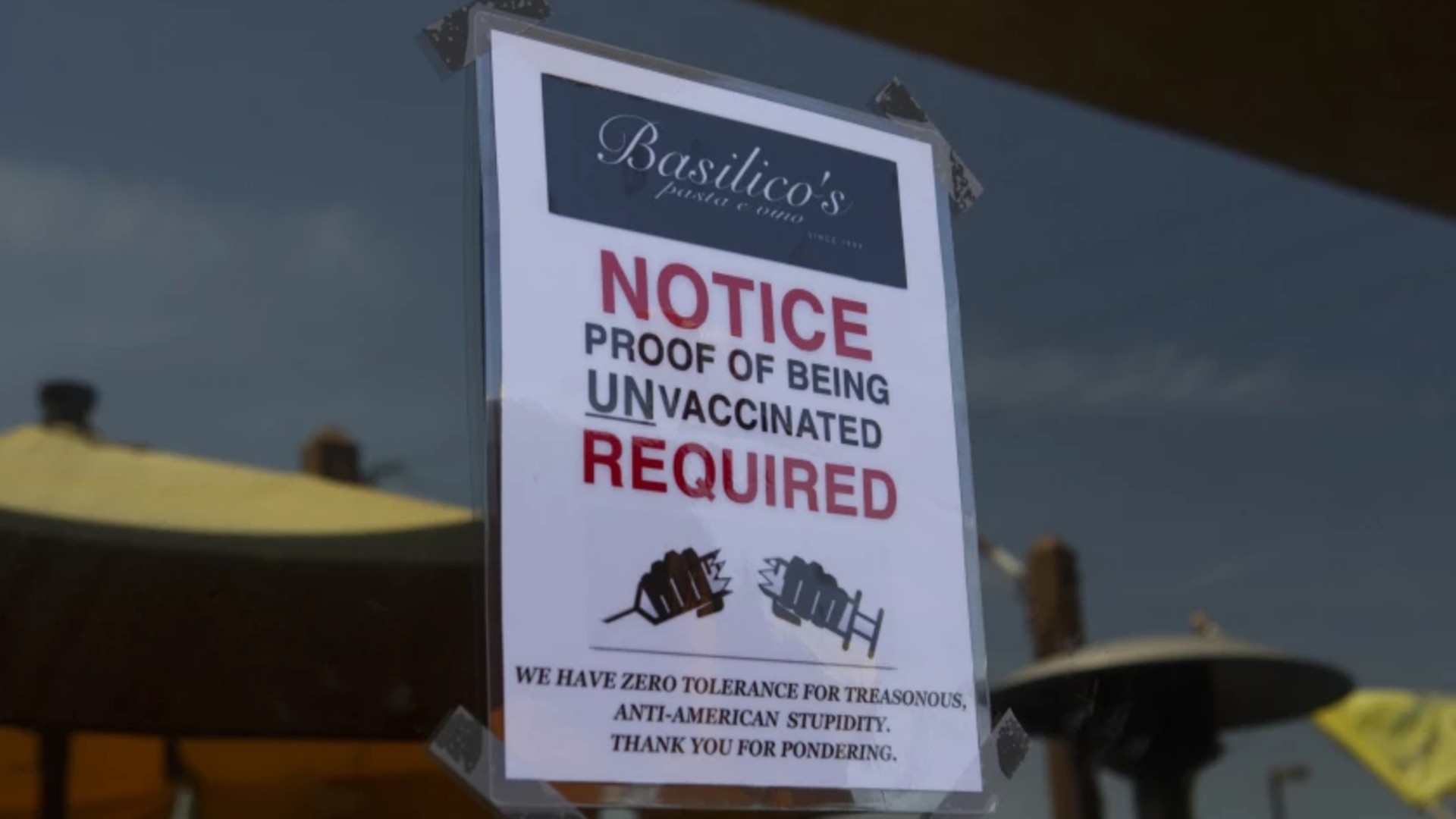 A sign outside Basilico’s restaurant in Huntington Beach says patrons must be unvaccinated to enter.(Madeleine Hordinski / Los Angeles Times)