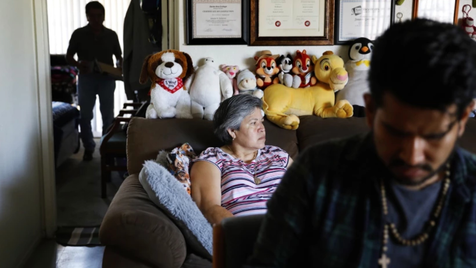 Jonatan Gutierrez, foreground, and parents Rocio Urzua and Pablo Gutierrez are shown at home in Santa Ana on July 2. Medi-Cal expansion will offer relief to income-eligible adults 50 and older regardless of immigration status. (Christina House / Los Angeles Times)