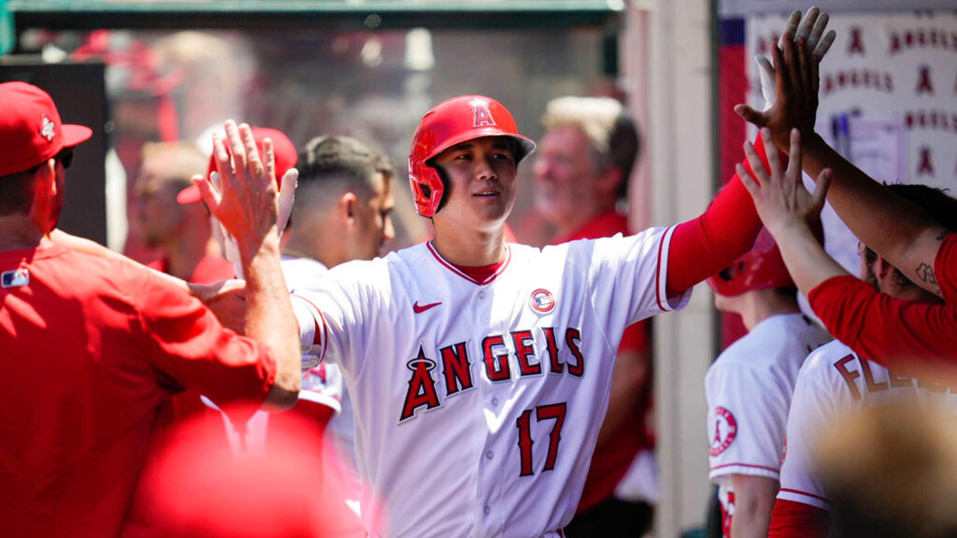 Los Angeles Angels designated hitter Shohei Ohtani (17) celebrates in the dugout with teammates after hitting a home run during the third inning of a baseball game against the Baltimore Orioles Sunday, July 4, 2021, in Anaheim, Calif. (AP Photo/Ashley Landis)