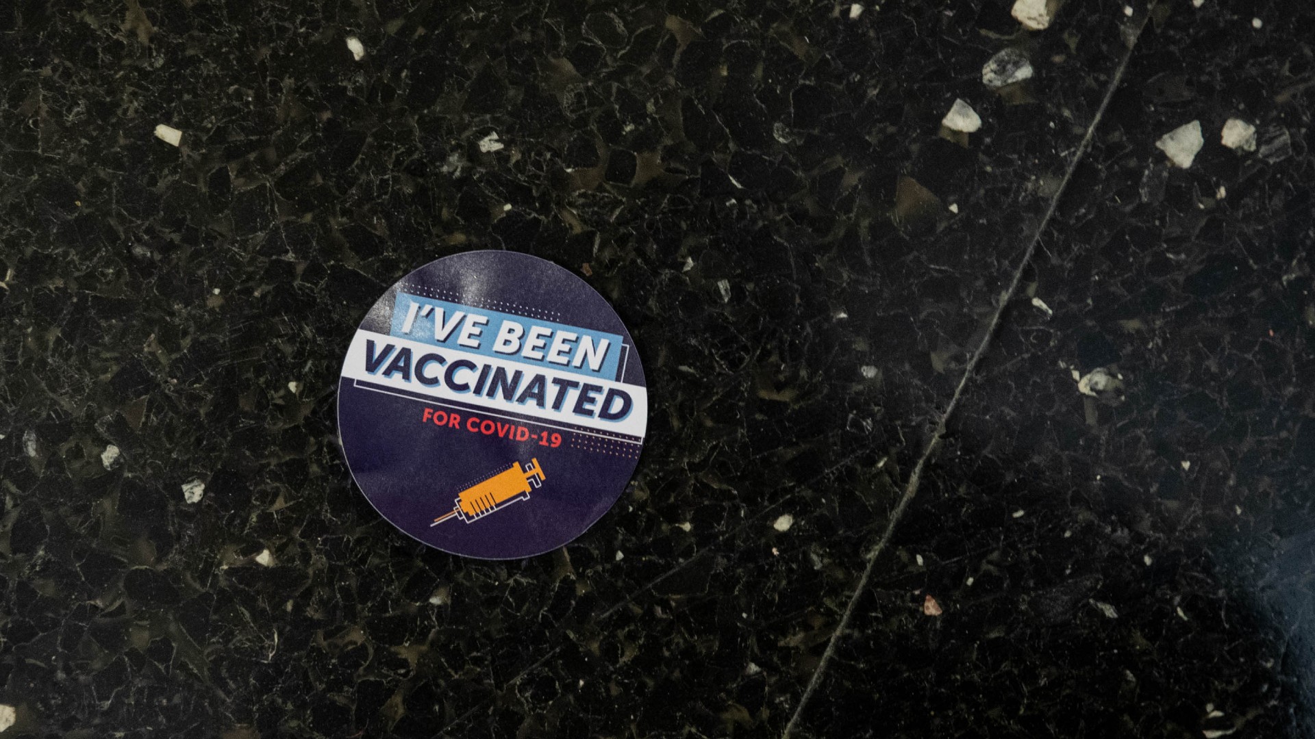 A sticker that reads Ive been vaccinated for COVID-19 is seen on the floor in a hallway at Thomas Jefferson University Hospital in Philadelphia, Pennsylvania on December 16, 2020. (GABRIELLA AUDI/AFP via Getty Images)