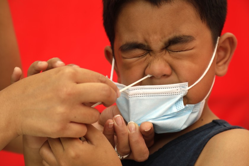 A first-grader gets a coronavirus test before starting school in an undated photo. (Genaro Molina / Los Angeles Times)