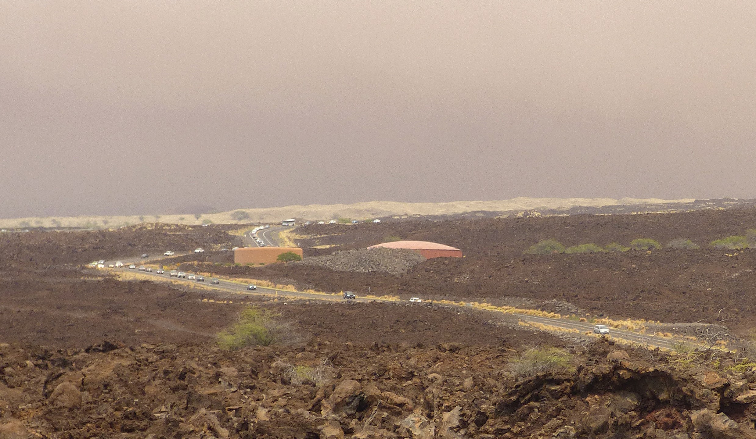 Vehicles are backed up on Waikoloa Road after a mandatory evacuation was ordered as a wildfire approached the Waikoloa Village area of Hawaii, Sunday, Aug. 1, 2021. A second emergency route was later opened to provide residents another way out. (Chelsea Jensen/West Hawaii Today via AP)