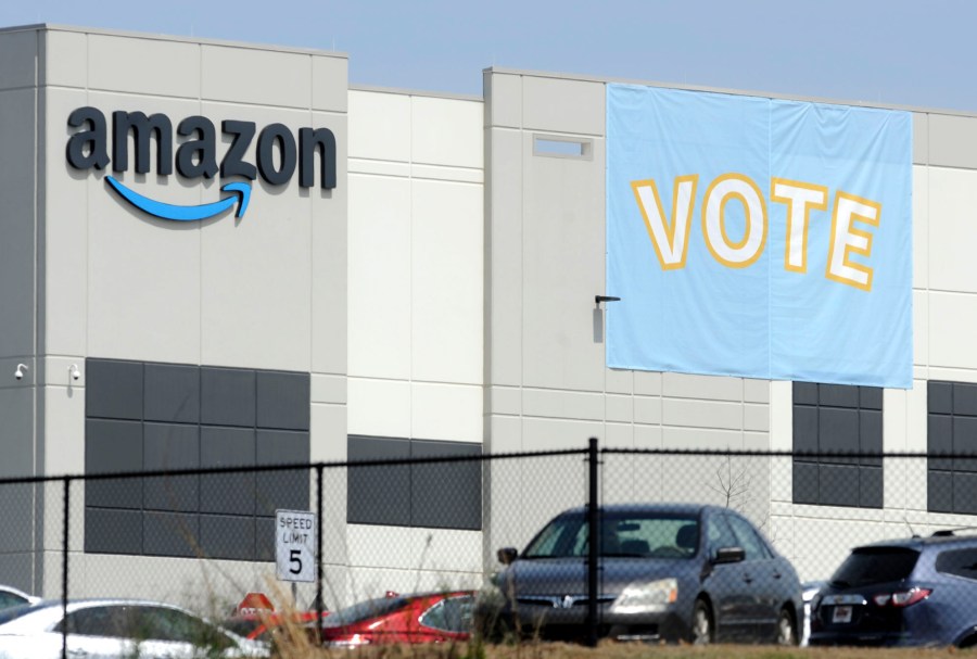 In this March 30, 2021 file photo, a banner encouraging workers to vote in labor balloting is shown at an Amazon warehouse in Bessemer, Ala. (AP Photo/Jay Reeves, File)