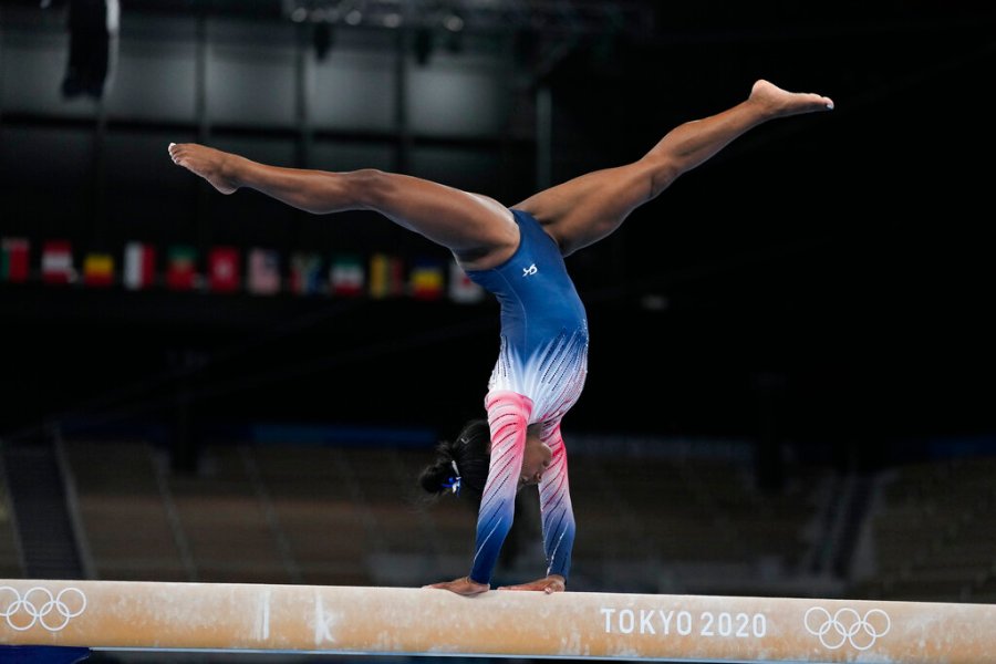 Simone Biles, of the United States, warms up prior to the artistic gymnastics balance beam final at the 2020 Summer Olympics, Tuesday, Aug. 3, 2021, in Tokyo, Japan. (AP Photo/Ashley Landis)