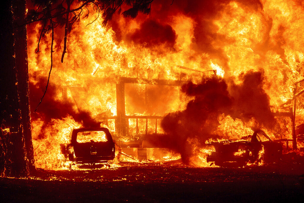 Flames consume a home on Highway 89 as the Dixie Fire tears through the Greenville community of Plumas County, Calif., on Wednesday, Aug. 4, 2021. (AP Photo/Noah Berger)