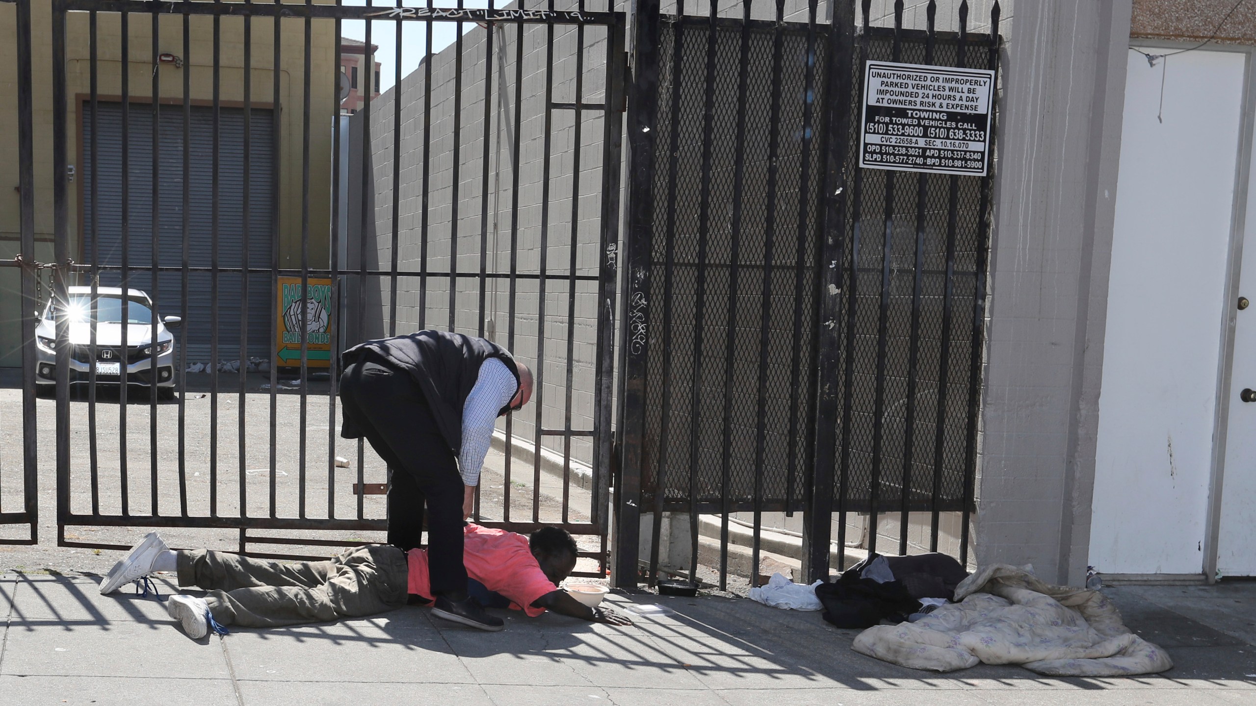 In this June 17, 2021, file photo, the Governor's security detail detains Serge Chaumette after he allegedly chucked a water bottle at California Governor Gavin Newsom during a visit to a small business in Oakland, Calif. (Ray Chavez/Bay Area News Group via AP, File)