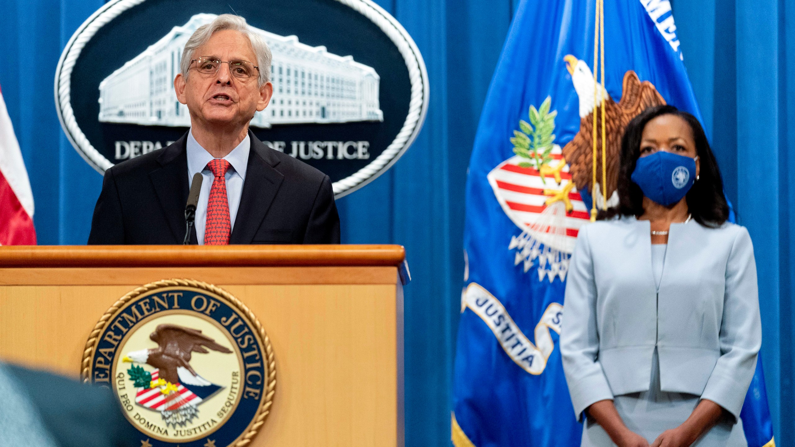 Attorney General Merrick Garland, accompanied by Assistant Attorney General for Civil Rights Kristen Clarke, right, speaks at a news conference at the Department of Justice in Washington on Aug. 5, 2021, to announce that the Department of Justice is opening an investigation into the city of Phoenix and the Phoenix Police Department. (AP Photo/Andrew Harnik)