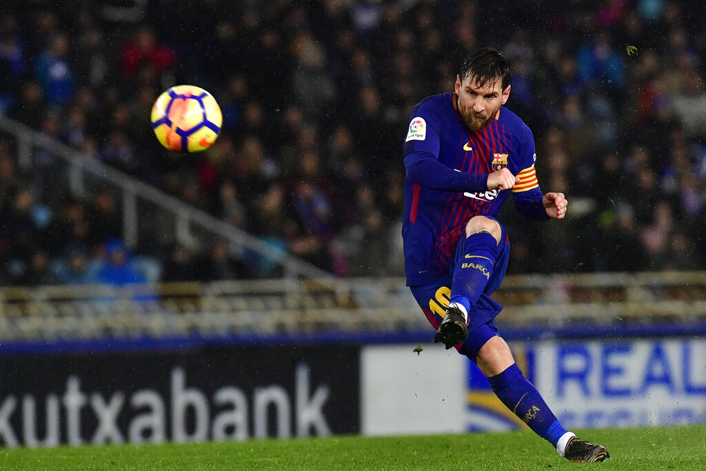 In this Jan.14, 2018 file photo FC Barcelona's Lionel Messi kicks the ball and scores the fourth goal of his team against Real Sociedad at Anoeta stadium, in San Sebastian, northern Spain. (AP Photo/Alvaro Barrientos, File)