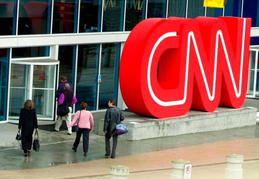 This Jan. 17, 2001 file photo shows pedestrians entering CNN Center, the headquarters for CNN, in downtown Atlanta. CNN has fired three employees for violating its policy that employees must be vaccinated against the COVID-19 virus. The firings were revealed Thursday, Aug. 5, 2021 as part of a memo sent by Jeff Zucker, chairman of WarnerMedia news and sports. (AP Photo/Ric Feld, File)