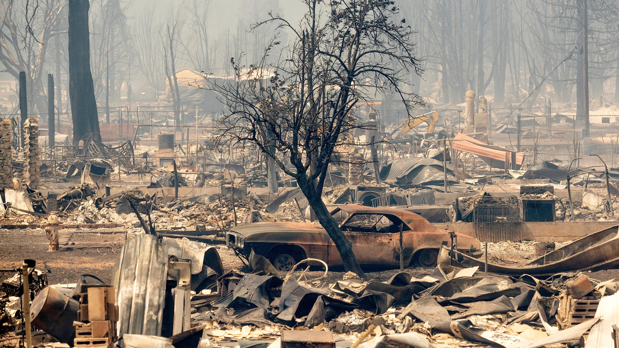 Homes and cars destroyed by the Dixie Fire line central Greenville on Thursday, Aug. 5, 2021, in Plumas County, Calif. (AP Photo/Noah Berger)