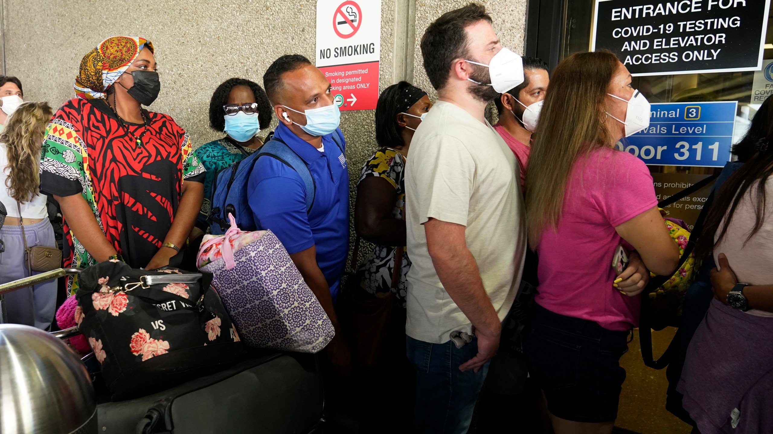 Passengers wait in a long line to get a COVID-19 test to travel overseas at Fort Lauderdale-Hollywood International Airport, Friday, Aug. 6, 2021, in Fort Lauderdale, Fla. (AP Photo/Marta Lavandier)