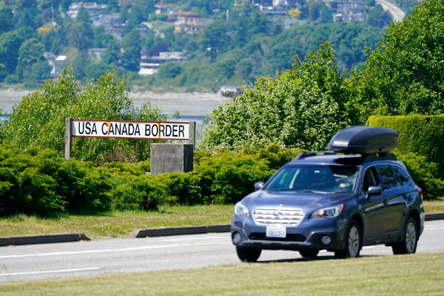 In this June 8, 2021, file photo, a car heads into the U.S. from Canada at the Peace Arch border crossing in Blaine, Wash. (AP Photo/Elaine Thompson, File)