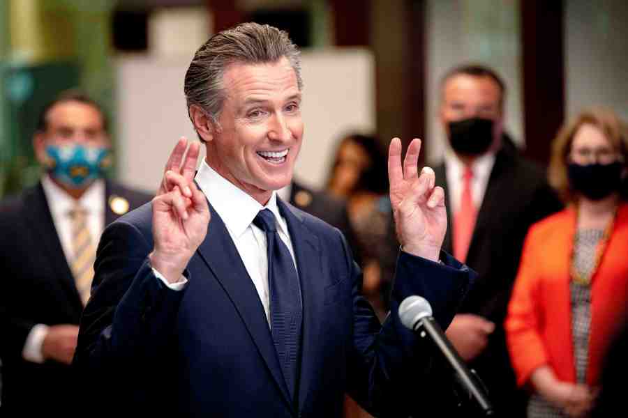 California Gov. Gavin Newsom makes a gesture as he speaks during a news conference at San Bernardino Unified School District Office after visiting Juanita B. Jones Elementary School in San Bernardino, Calif., Friday, Aug. 6, 2021. (Watchara Phomicinda/The Orange County Register via AP)