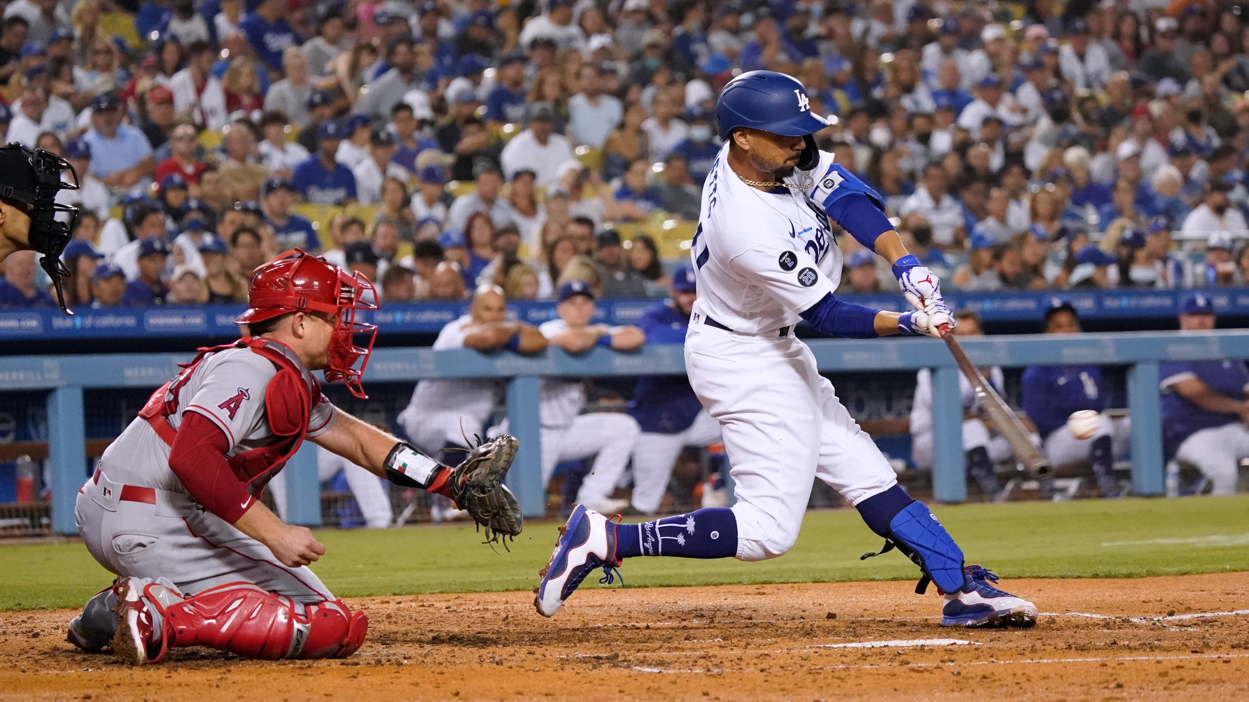 Los Angeles Dodgers' Mookie Betts drives in a run with a single during the fourth inning of the team's baseball game against the Los Angeles Angels on Aug. 6, 2021, in Los Angeles. Betts was taken out of the game with a sore him and was later placed on the injured list. (Marcio Jose Sanchez/Associated Press)