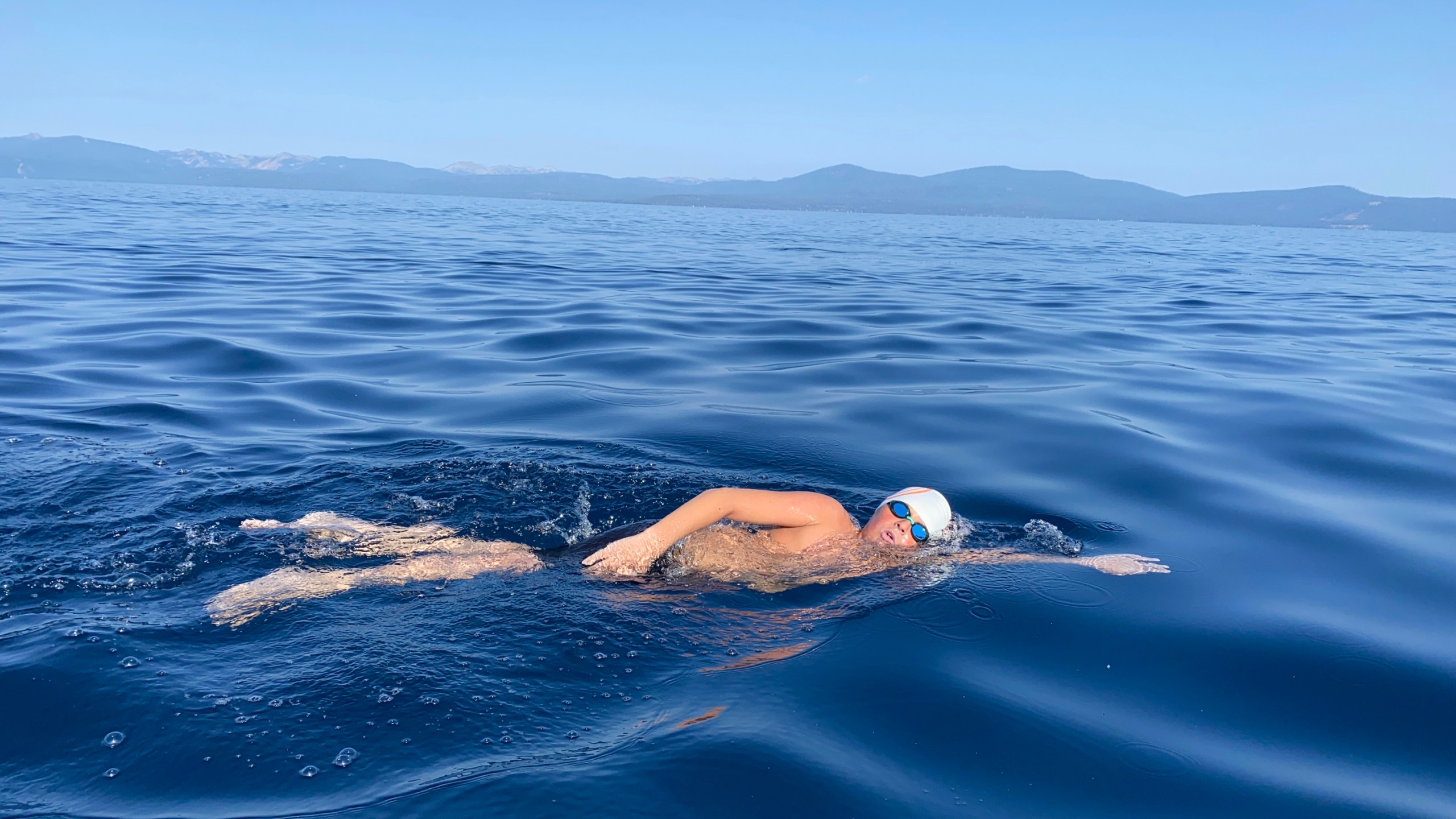 This Aug. 1, 2021 image provided by Jillian Savage shows James Savage, 14, of Los Banos, Calif. as he swam the entire 21.3-mile length of Lake Tahoe from South Lake Tahoe, California to Incline Village, Nevada. He became the youngest person ever to make the swim and complete the coveted Tahoe Triple Crown. He completed the two other legs of the triple crown earlier, each 10 miles are longer. (AP Photo/By Jillian Savage)