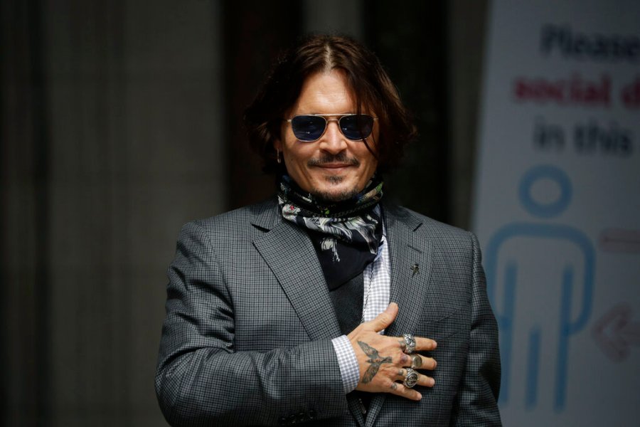 In this Thursday, July 23, 2020 file photo, U.S. actor Johnny Depp gestures to fans and the media as he arrives at the High Court in London. (AP Photo/Matt Dunham, file)