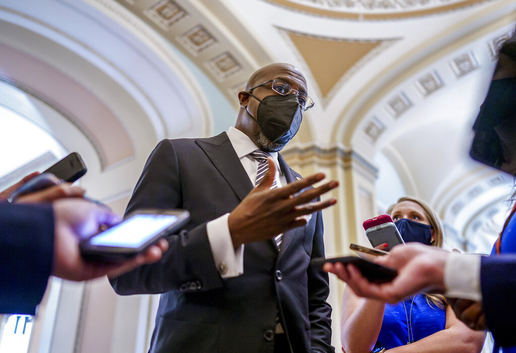 Sen. Raphael Warnock, D-Ga., a key figure on voting rights efforts, speaks to reporters after a huddle with other Democrats as they look to salvage their push to enact voting rights legislation, at the Capitol in Washington, Tuesday, Aug. 10, 2021. (AP Photo/J. Scott Applewhite)