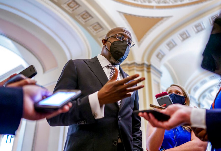 Sen. Raphael Warnock, D-Ga., a key figure on voting rights efforts, speaks to reporters after a huddle with other Democrats as they look to salvage their push to enact voting rights legislation, at the Capitol in Washington, Tuesday, Aug. 10, 2021. (AP Photo/J. Scott Applewhite)