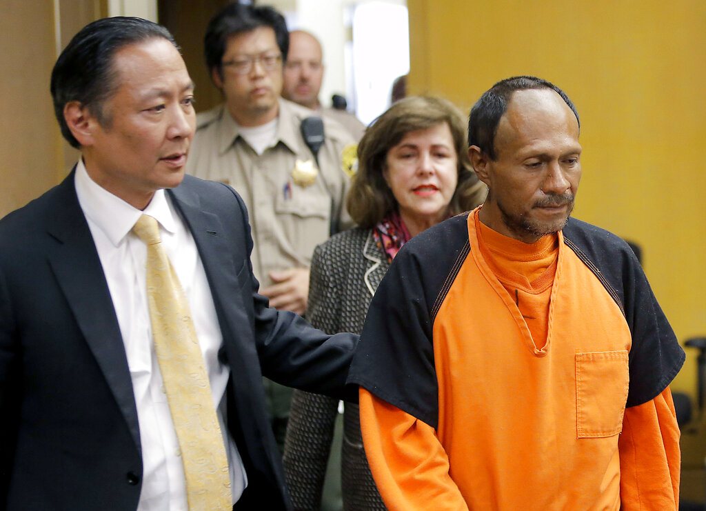 In this July 7, 2015 file pool photo, Juan Francisco Lopez-Sanchez, right, is lead into the courtroom for his arraignment at the Hall of Justice in San Francisco. (Michael Macor/San Francisco Chronicle via AP, File)