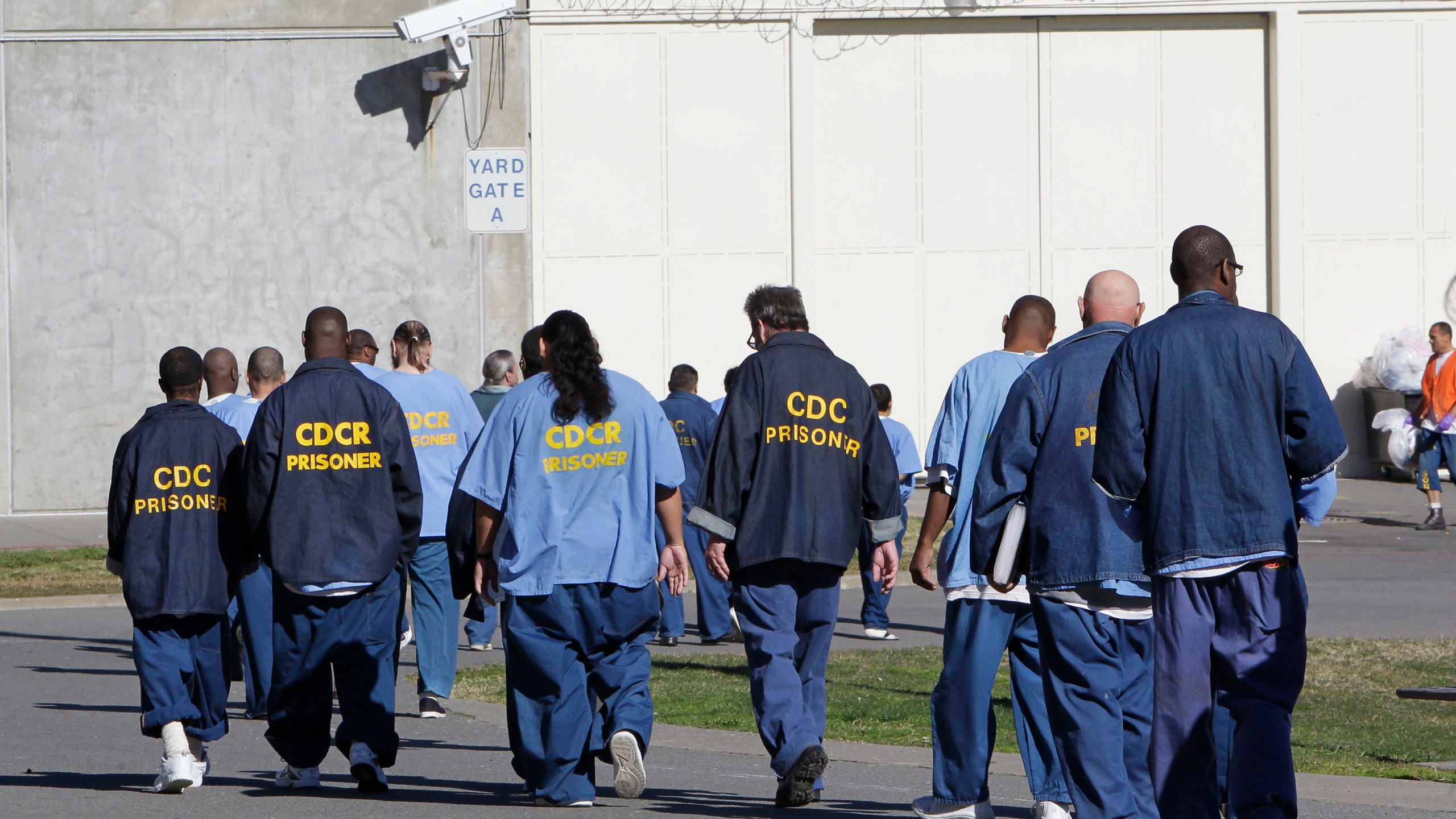 In this Feb. 26, 2013, file photo, inmates walk through the exercise yard at California State Prison Sacramento, near Folsom, Calif. (AP Photo/Rich Pedroncelli, File)