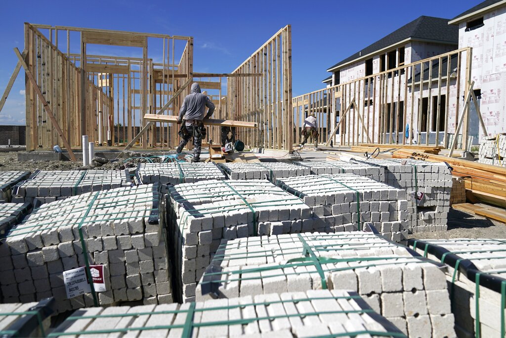 Workers erect the frame of a home being built in a new subdivision in Allen, Texas, Thursday, Aug. 12, 2021. (AP Photo/Tony Gutierrez)