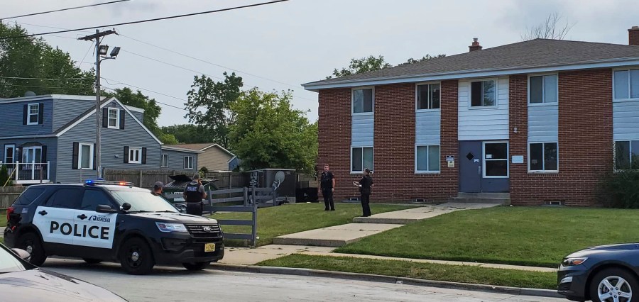 Kenosha police investigate a shooting at 40th Avenue and 45th Street on the city's north side Tuesday, Aug. 10, 2021, in Kenosha, Wis. A 19-year-old woman was using a handgun's laser sight as a cat toy when she accidentally shot a friend, according to prosecutors. The 19-year-old woman was charged Thursday with injury by negligent use of a weapon. (Terry Flores/The Kenosha News via AP)