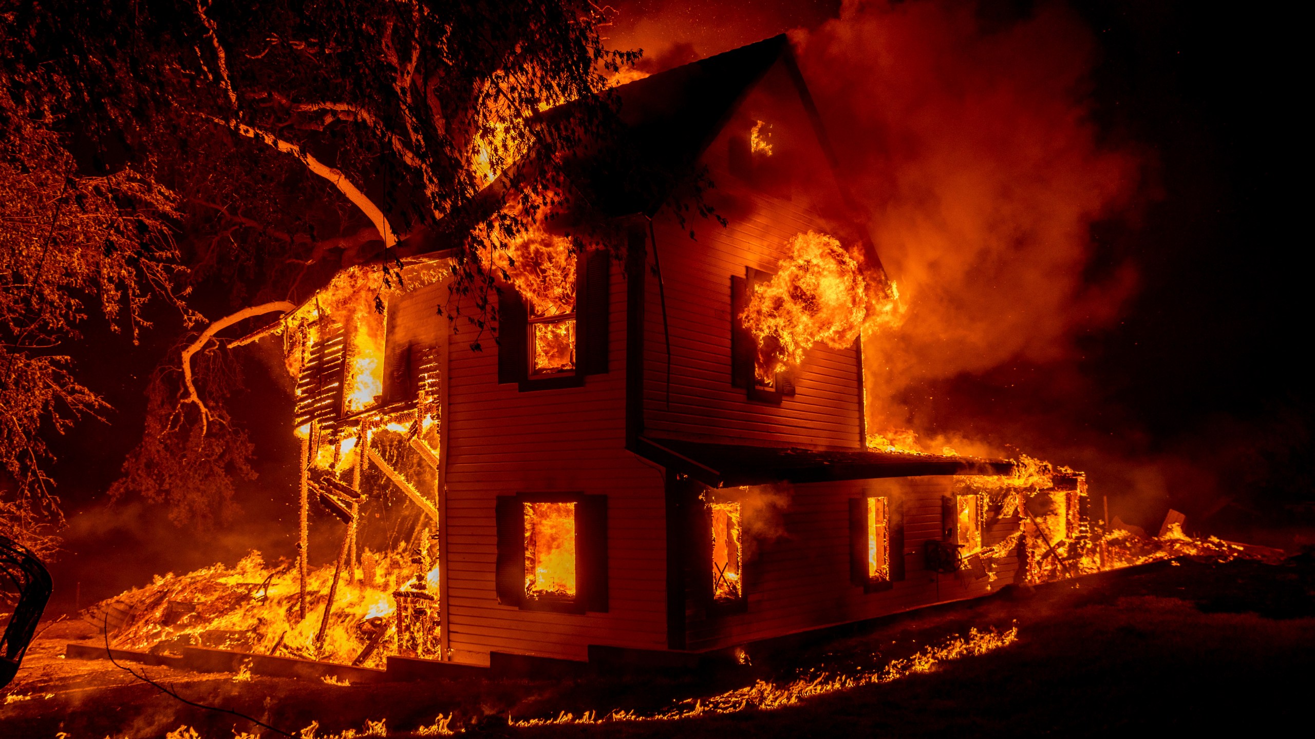 A home burns on Jeters Road as the Dixie Fire jumps Highway 395 south of Janesville, Calif., on Aug. 16, 2021. (Ethan Swope / Associated Press)