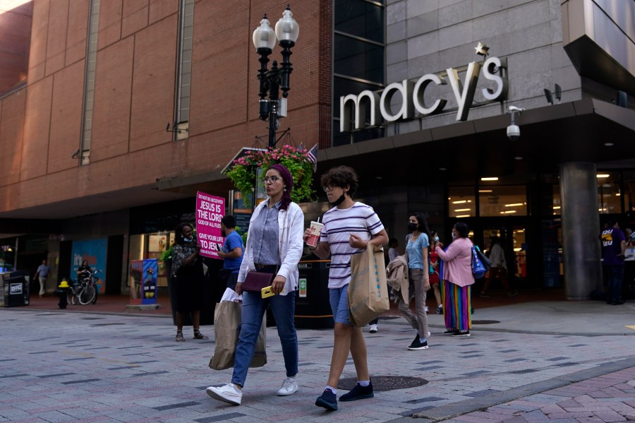 In this July 14, 2021 file photo, pedestrians pass the Macy's store in the Downtown Crossing shopping area, in Boston. (AP Photo/Charles Krupa, File)