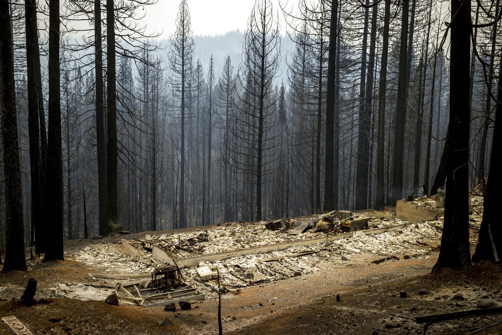 Scorched property destroyed by the Caldor Fire is seen in Grizzly Flats, Calif., on Wednesday, Aug. 18, 2021. (AP Photo/Ethan Swope)