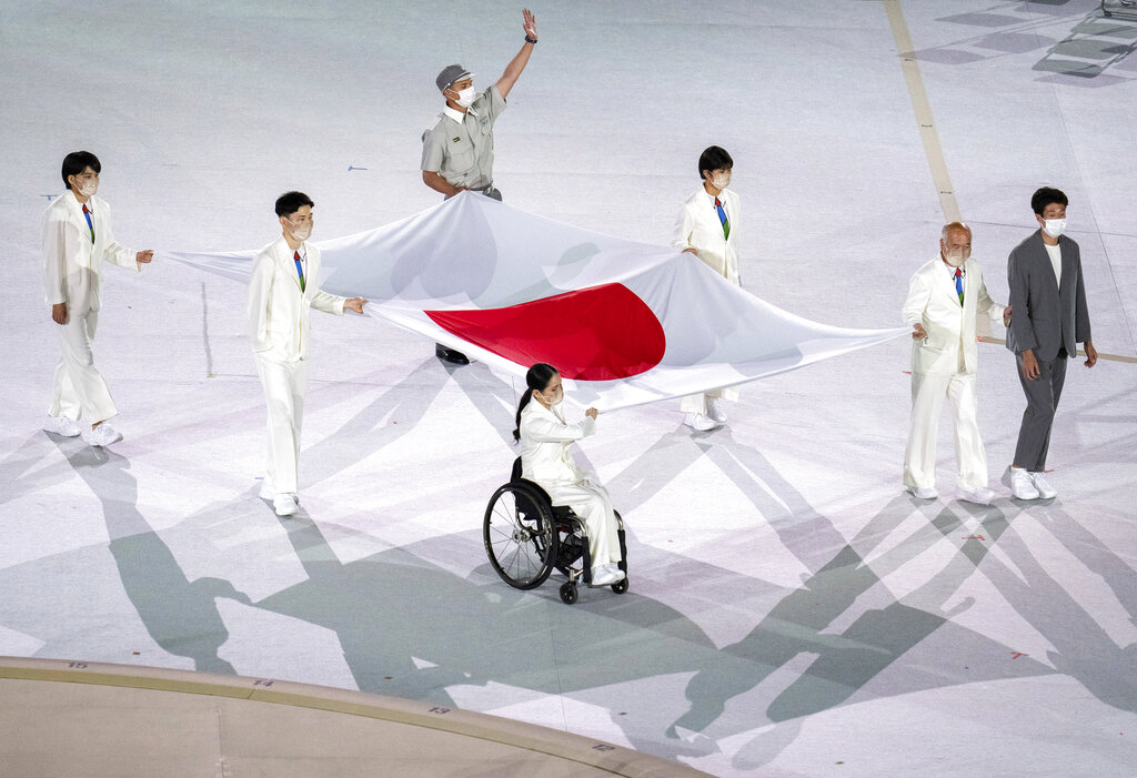 Athletes from Japan Miki Matheson, Mineho Ozaki, Taiyou Imai, Erina Yuguchi, Kaori Icho, and Tskumi Asatani carry the national flag of Japan into the Olympic Stadium at the start of the Paralympic Opening Ceremony Tokyo 2020 Paralympic Games in Tokyo, Tuesday, Aug. 24, 2021. (Joe Toth for OIS via AP)