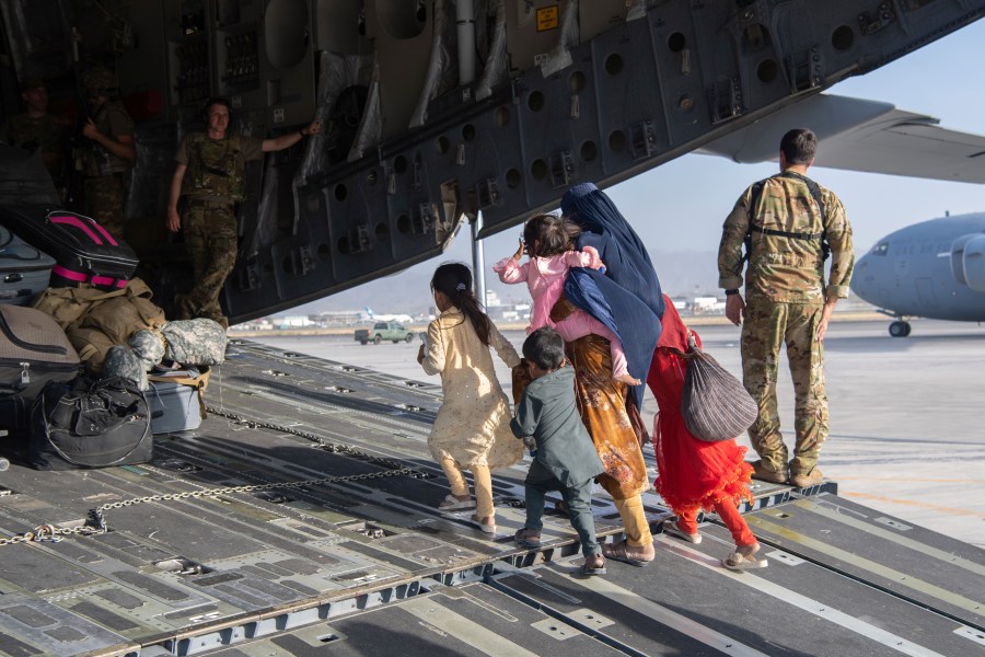 In this image provided by the U.S. Air Force, U.S. Air Force loadmasters and pilots assigned to the 816th Expeditionary Airlift Squadron, load people being evacuated from Afghanistan onto a U.S. Air Force C-17 Globemaster III at Hamid Karzai International Airport in Kabul, Afghanistan, Tuesday, Aug. 24, 2021. (Master Sgt. Donald R. Allen/U.S. Air Force via AP)