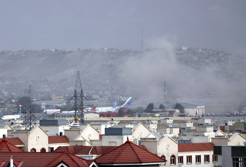 Smoke rises from explosion outside the airport in Kabul, Afghanistan on Aug. 26, 2021. The explosion went off outside Kabul’s airport, where thousands of people have flocked as they try to flee the Taliban takeover of Afghanistan. (AP Photo/Wali Sabawoon)