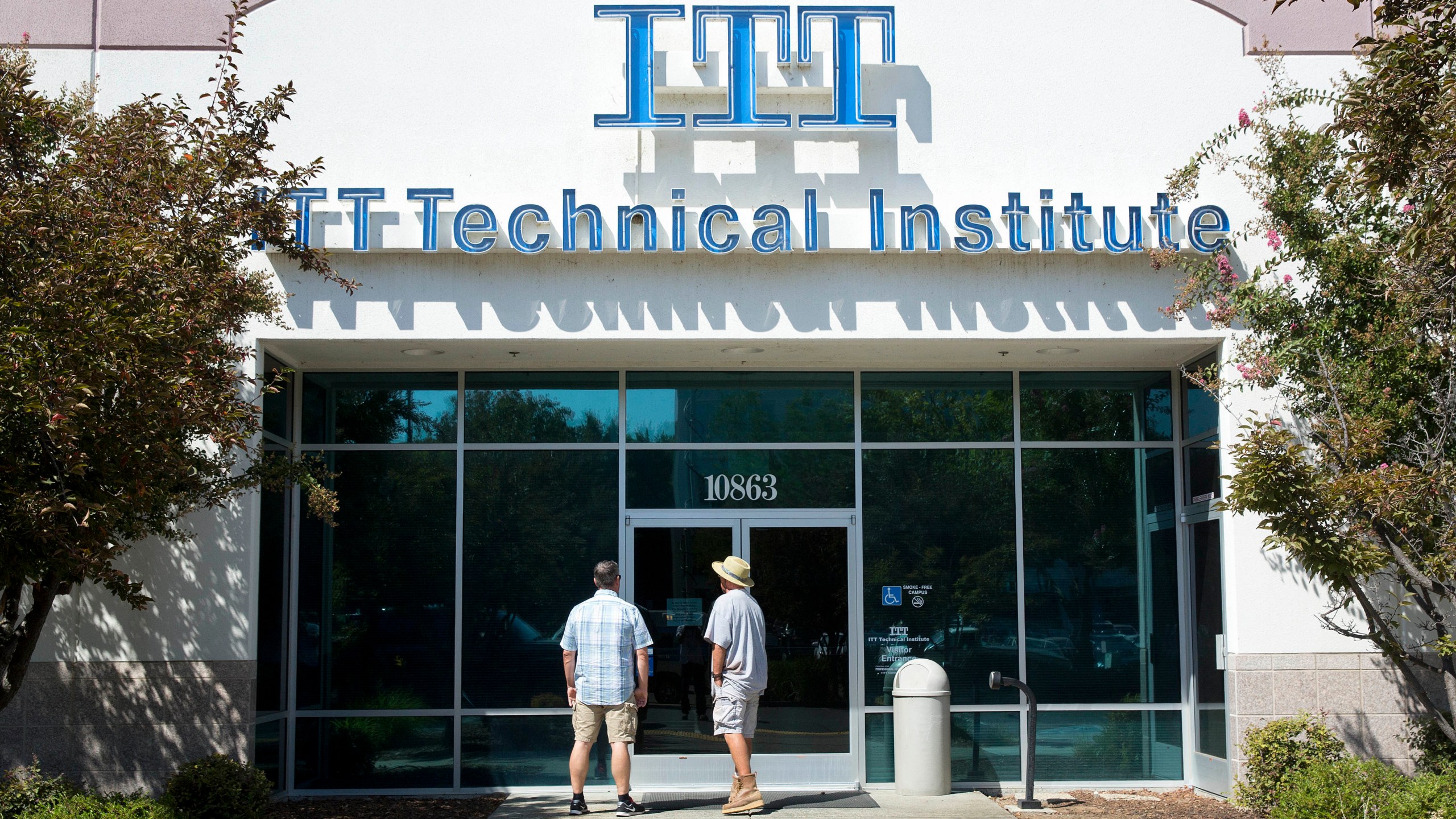 In this Sept. 6, 2016, file photo students find the doors locked to the ITT Technical Institute campus in Rancho Cordova, Calif. The U.S. Education Department announced Thursday, Aug. 26, 2021, it will forgive student debt for more than 100,000 borrowers who attended the now-defunct ITT Technical Institute chain but left before graduating. (AP Photo/Rich Pedroncelli, File)