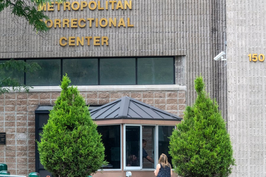 In this Aug. 13, 2019 file photo, an employee checks a visitor outside the Metropolitan Correctional Center in New York. (Mary Altaffer/Associated Press)