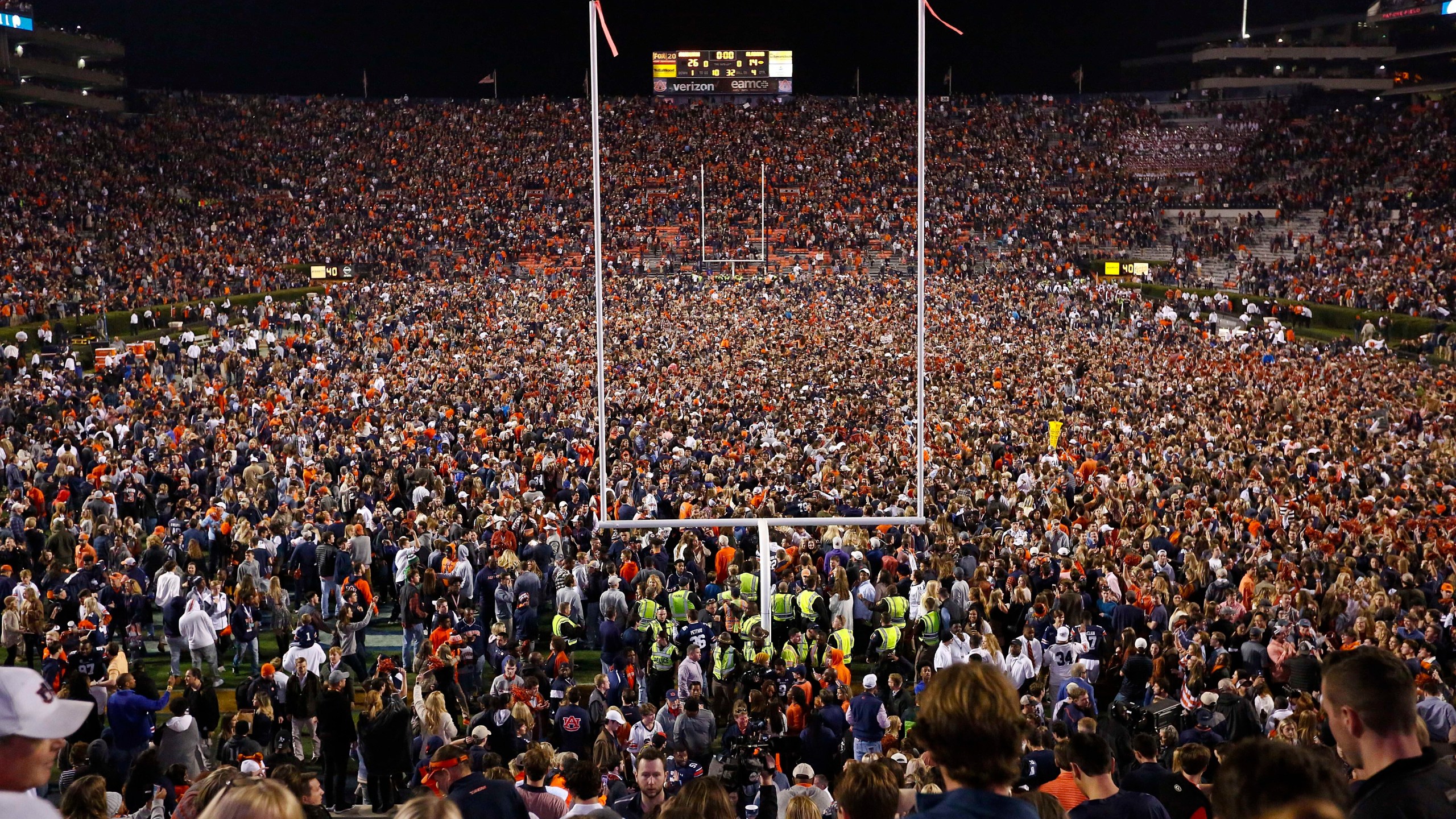 Fans rush the field after Auburn defeated Alabama in the Iron Bowl NCAA college football game, Saturday, Nov. 25, 2017, in Auburn, Ala. (AP Photo/Brynn Anderson, File)