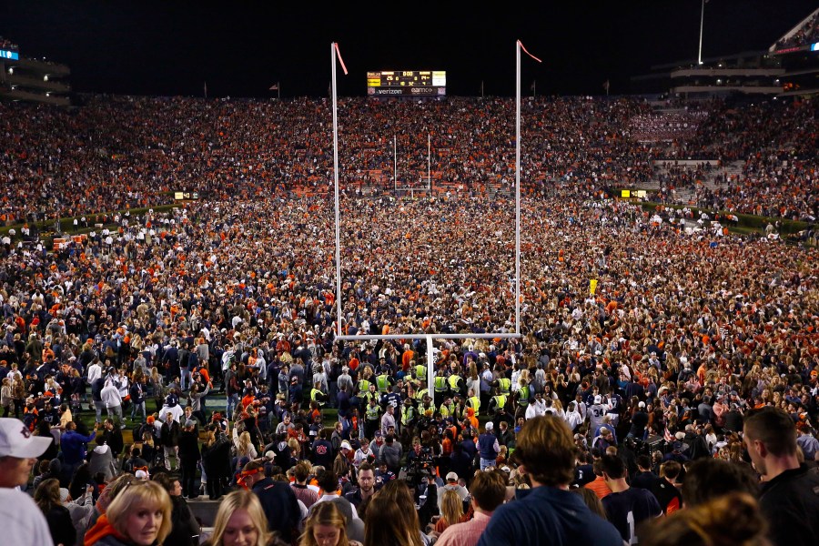 Fans rush the field after Auburn defeated Alabama in the Iron Bowl NCAA college football game, Saturday, Nov. 25, 2017, in Auburn, Ala. (AP Photo/Brynn Anderson, File)