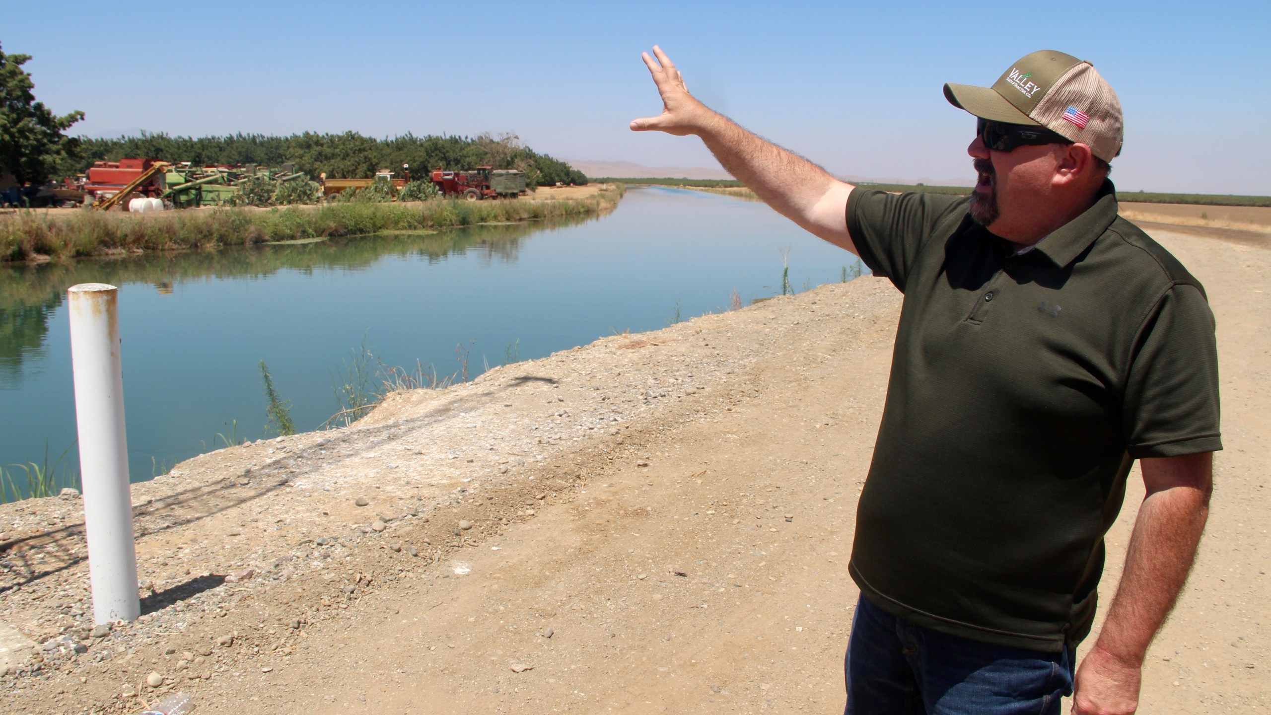 Kevin Spesert, public affairs and real estate manager for the Sites Project Authority, points out the main canal of the Glenn Colusa Irrigation District, on Friday, July 23, 2021, near Sites, Calif. The canal would be one of the primary sources of water for the planned Sites Reservoir, a project that would be large enough to supply enough water for 1.5 million households each for one year.(AP Photo/Adam Beam)