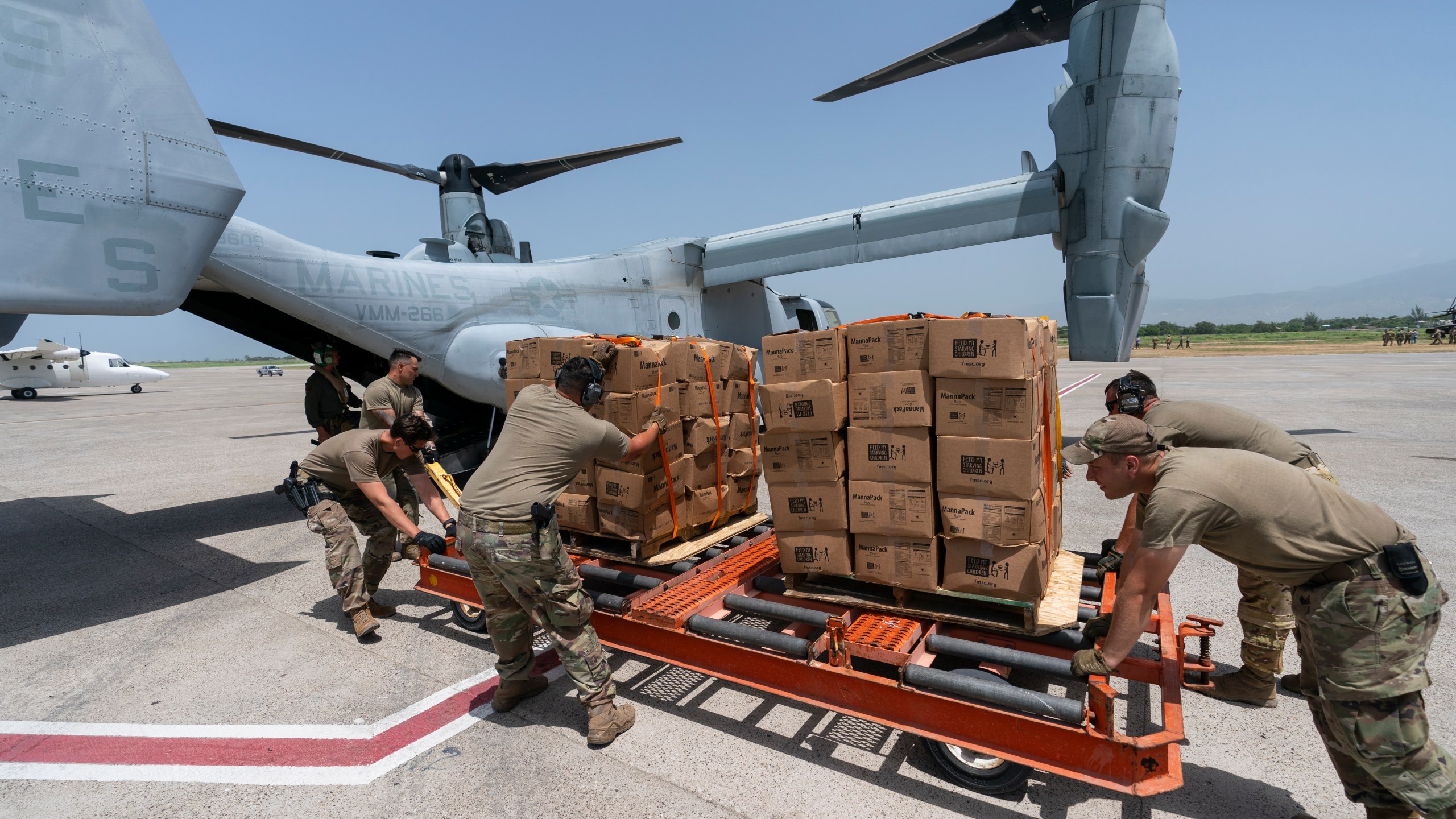 Food is loaded onto a VM-22 Osprey at Toussaint Louverture International Airport, Saturday, Aug. 28, 2021, in Port-au-Prince, Haiti. The VMM-266, "Fighting Griffins," from Marine Corps Air Station New River, from Jacksonville, N.C., are flying in support of Joint Task Force Haiti after a 7.2 magnitude earthquake on Aug. 22, caused heavy damage to the country. (AP Photo/Alex Brandon)