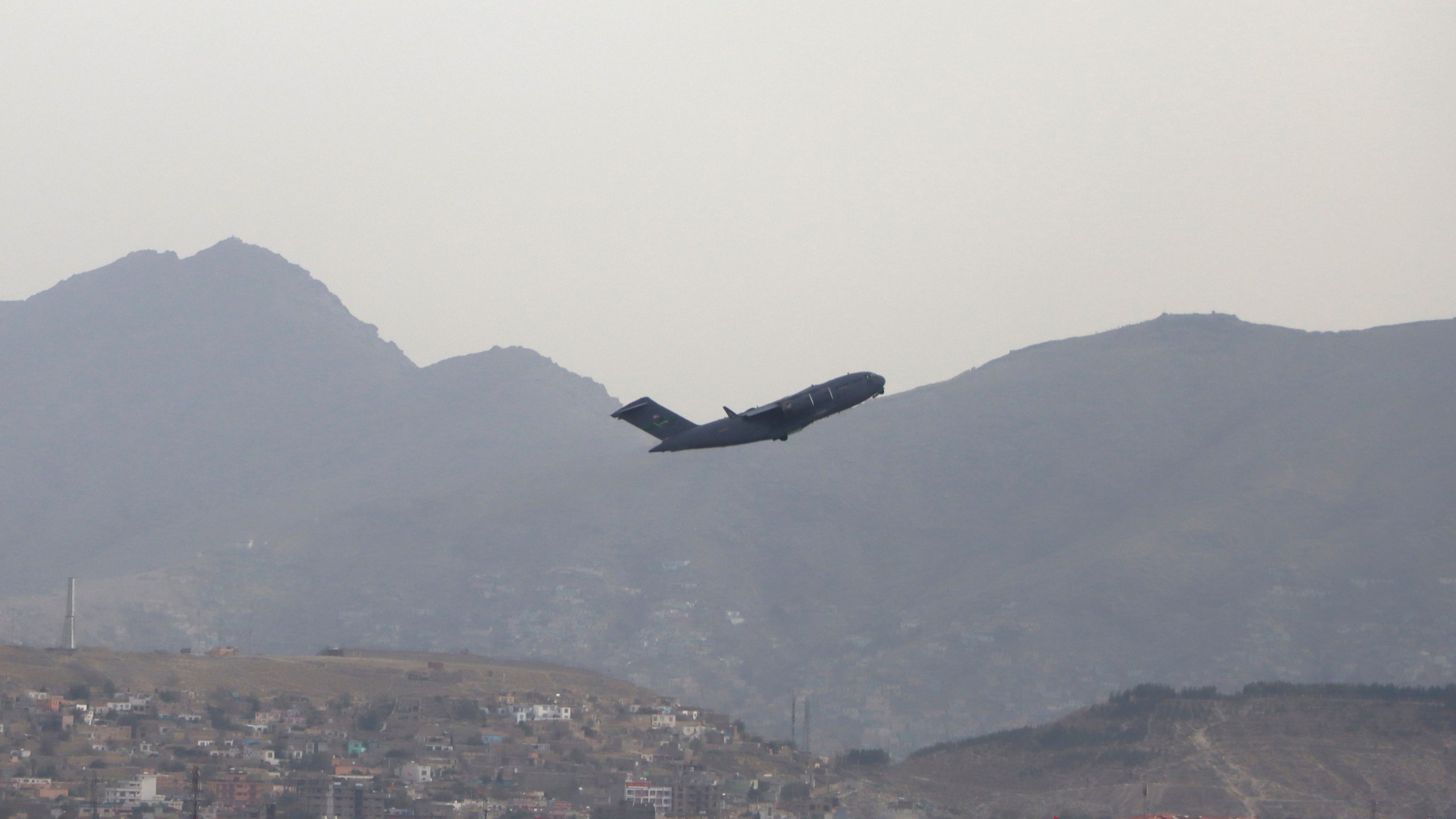 A U.S. military aircraft takes off from the Hamid Karzai International Airport in Kabul, Afghanistan, on Aug. 30, 2021. (Wali Sabawoon / Associated Press)