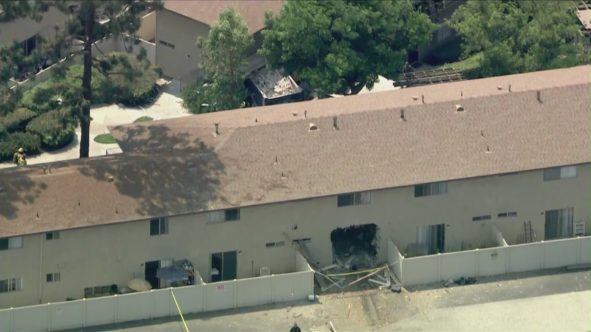 A dump truck crashed through a 57 Freeway wall and an apartment building in Anaheim on Aug. 24, 2021. (KTLA)